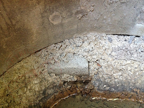 Sump in neighbours' garden that's not benched or made watertight.