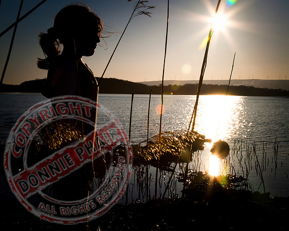The Girl, the Reeds and the Sunset.